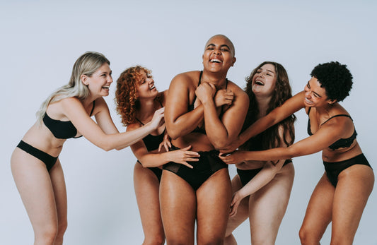 Diverse women of different ages and skin tones relaxing in a natural light space, representing hormonal balance, wellness, and modern beauty.